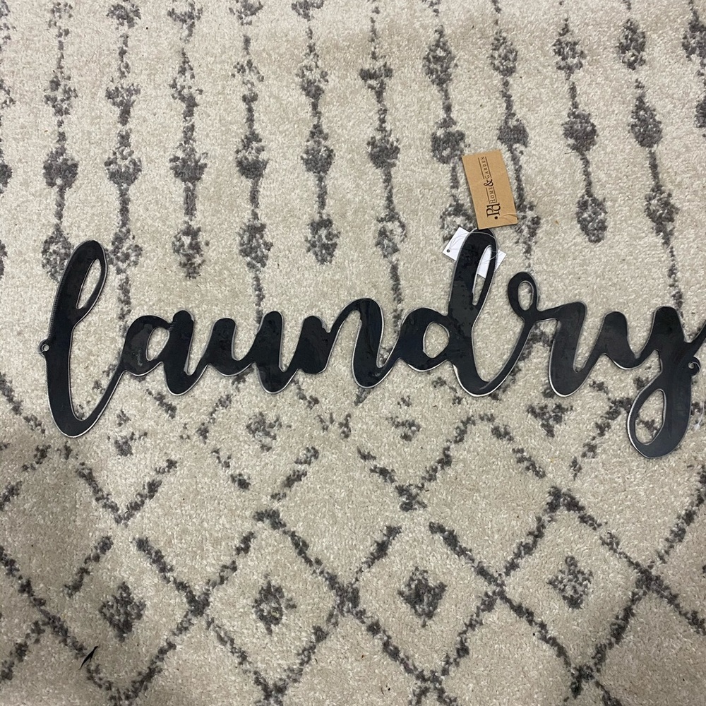Black metal “laundry” sign